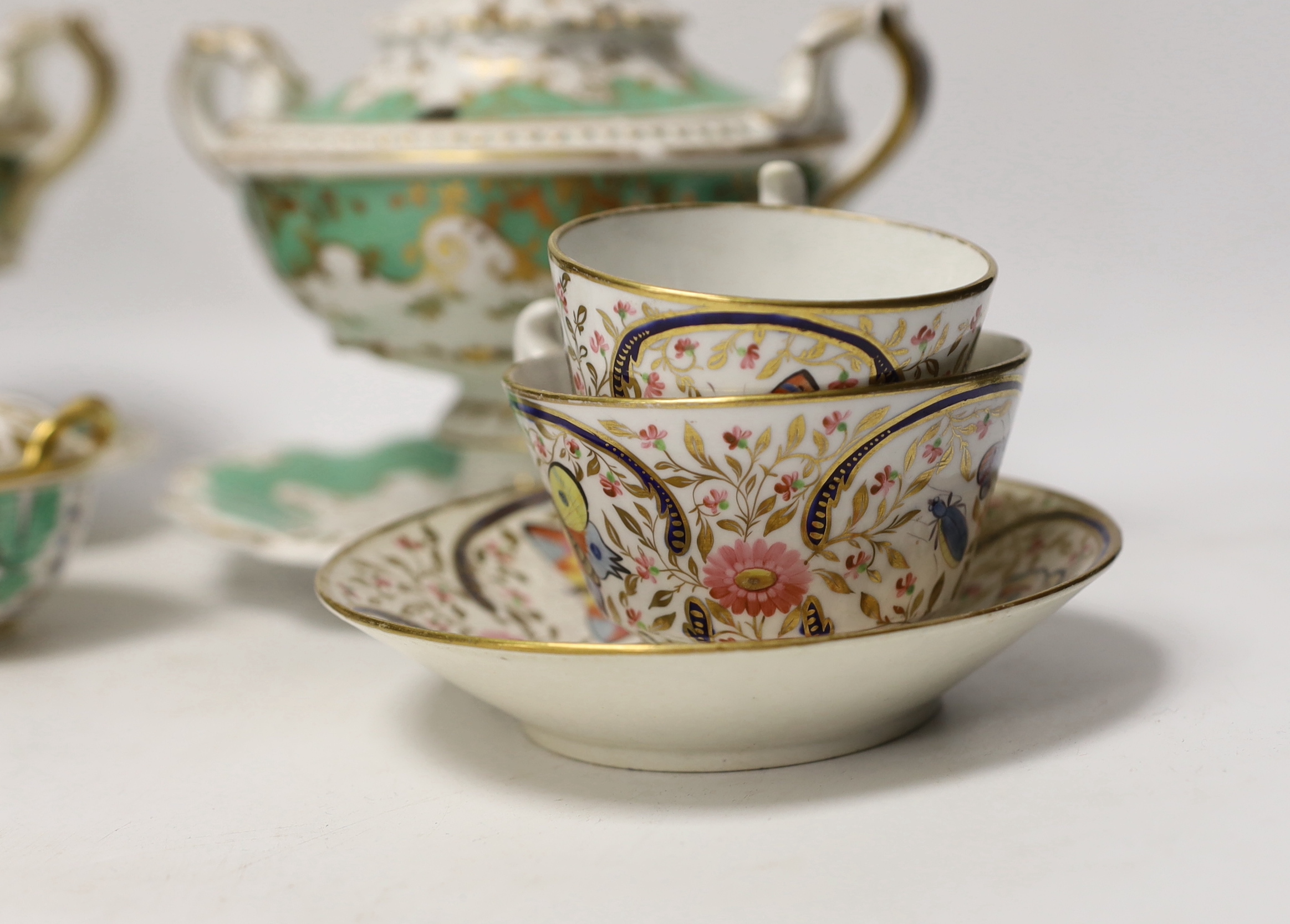 Early 19th century English porcelain including a Wedgwood pot pourri bowl and cover, two sauce tureens covers with integral stands, a butterfly painted trio and a bird painted spill vase